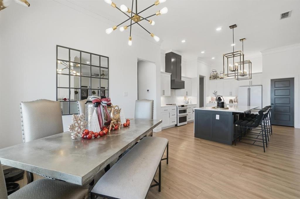 136 Mistletoe Ridge Lawn, TX 79530 - Photo 15 of 37 Dining space featuring a chandelier, light wood-type flooring, crown molding, and recessed lighting