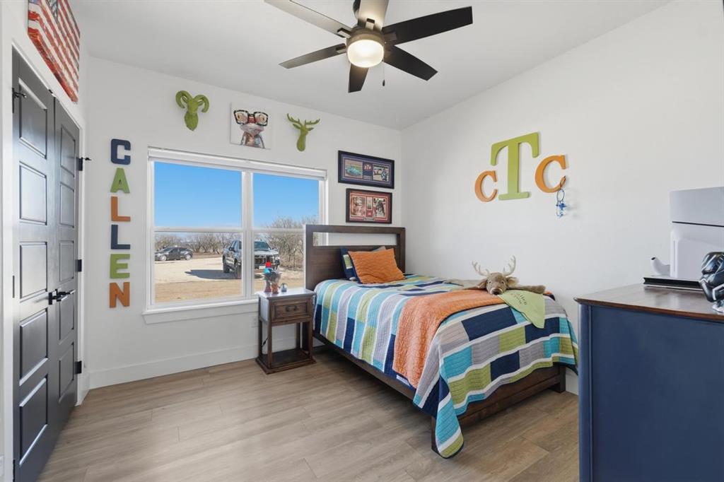 136 Mistletoe Ridge Lawn, TX 79530 - Photo 16 of 37 Bedroom featuring light wood finished floors, a ceiling fan, and freestanding refrigerator