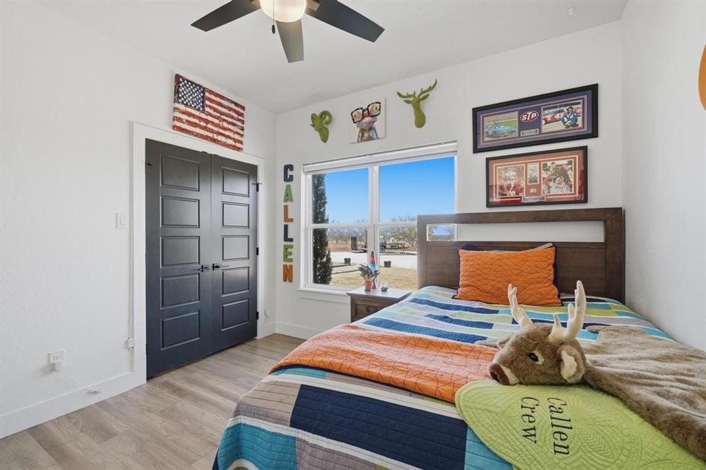 136 Mistletoe Ridge Lawn, TX 79530 - Photo 17 of 37 Bedroom featuring light wood-style flooring, a ceiling fan, and a closet