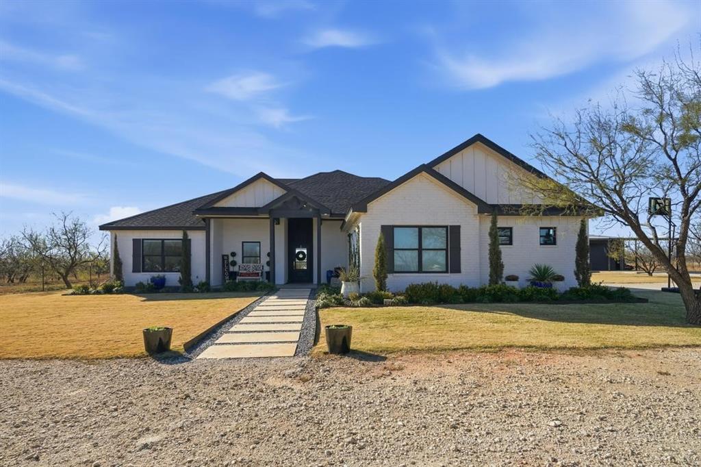 136 Mistletoe Ridge Lawn, TX 79530 - Photo 2 of 37 Modern farmhouse featuring brick siding, a porch, a front lawn, and board and batten siding