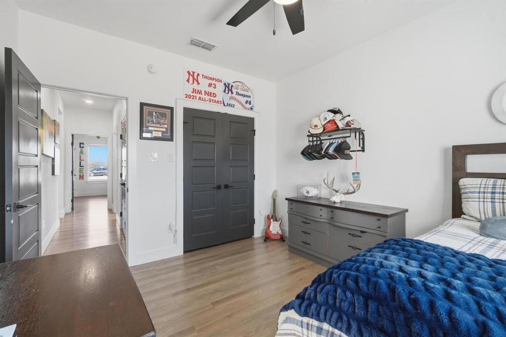136 Mistletoe Ridge Lawn, TX 79530 - Photo 20 of 37 Bedroom featuring light wood-type flooring, a ceiling fan, and a closet