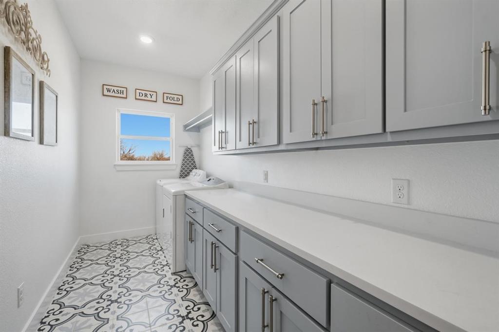 136 Mistletoe Ridge Lawn, TX 79530 - Photo 21 of 37 Laundry room with cabinet space, washer and dryer, and light tile patterned flooring