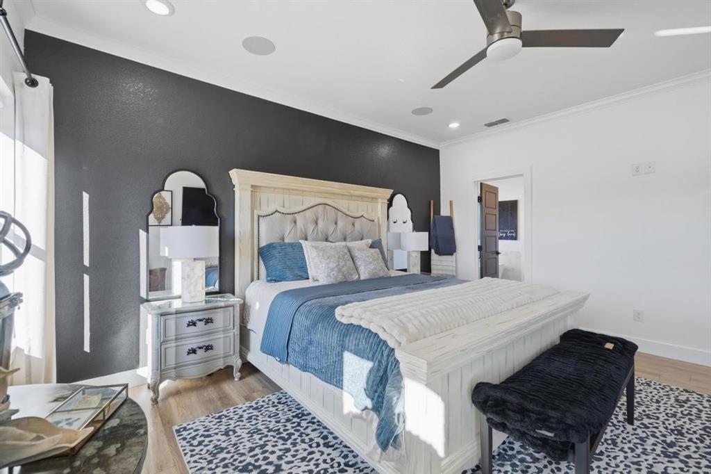 136 Mistletoe Ridge Lawn, TX 79530 - Photo 25 of 37 Bedroom featuring crown molding, a ceiling fan, light wood-style floors, connected bathroom, and recessed lighting