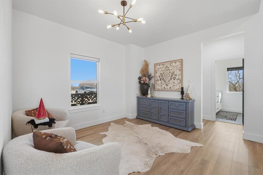 136 Mistletoe Ridge Lawn, TX 79530 - Photo 8 of 37 Sitting room with a chandelier, wood finished floors, and plenty of natural light