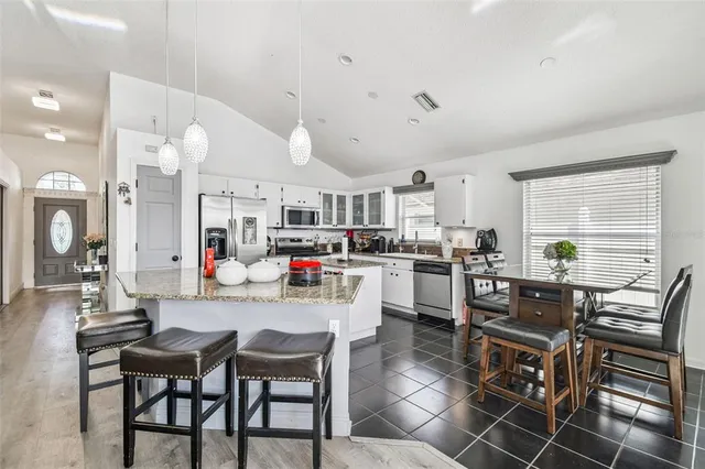 a kitchen that has a lot of cabinets in it