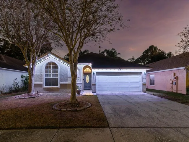 a backyard of a house with table and chairs