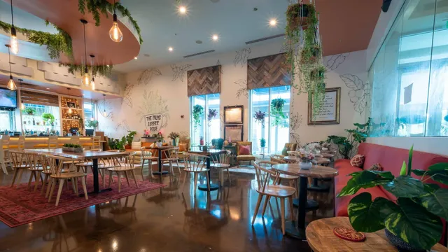 a very nice looking dining room with lots of furniture and plants