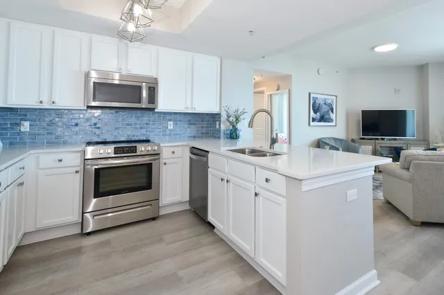 a kitchen with appliances a sink and cabinets