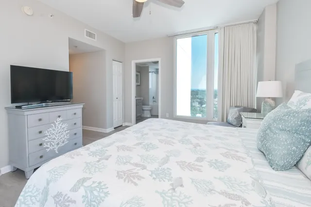 a bedroom with a bed and a flat screen tv in it