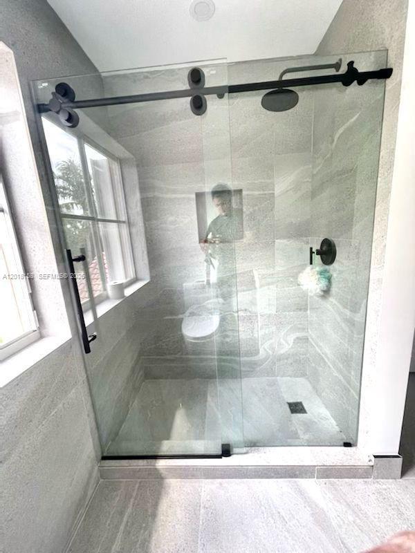 709 Bald Cypress Road Weston, FL 33327 - Photo 15 of 20 a bathroom with a shower