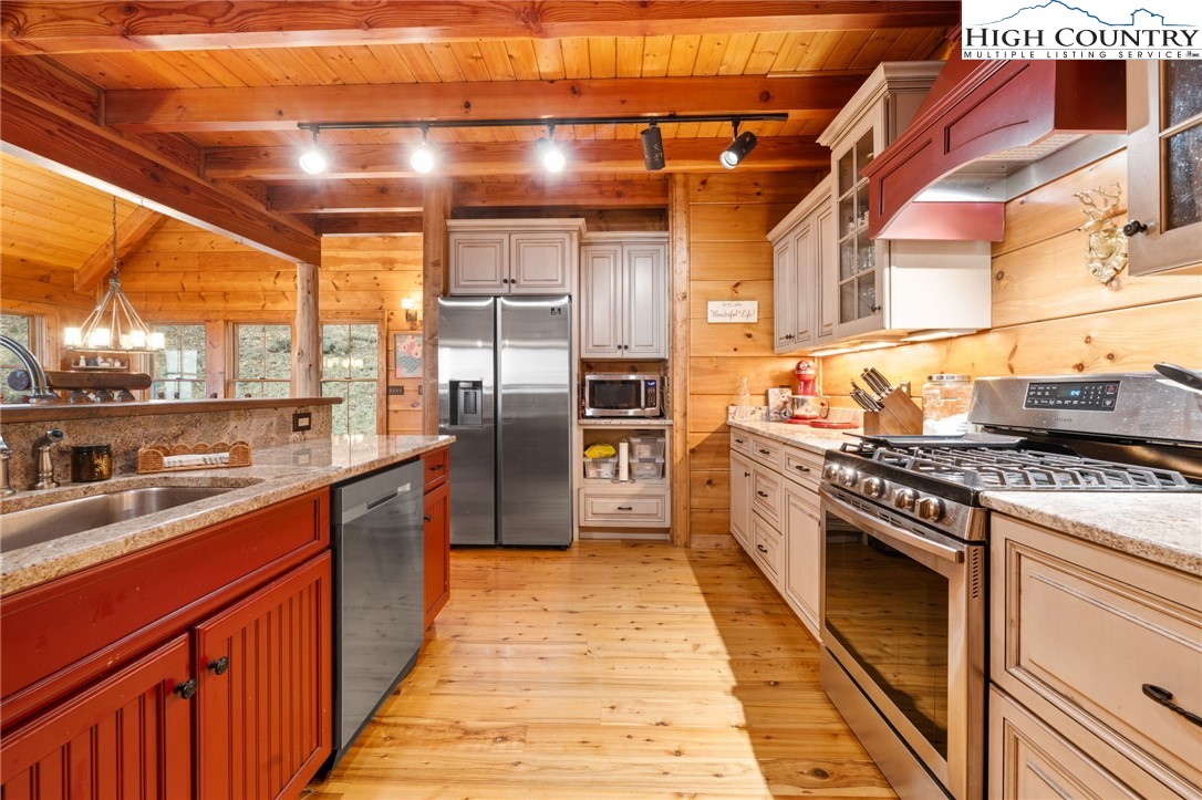 635 Acorn Road Zionville, NC 28698 - Photo 16 of 50 a kitchen with stainless steel appliances granite countertop a stove a sink and dishwasher
