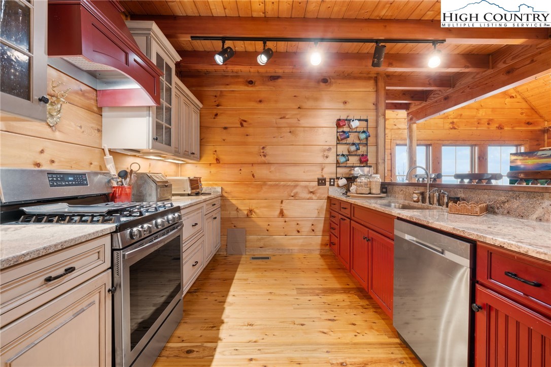 635 Acorn Road Zionville, NC 28698 - Photo 17 of 50 a kitchen with stainless steel appliances granite countertop a stove a sink and dishwasher