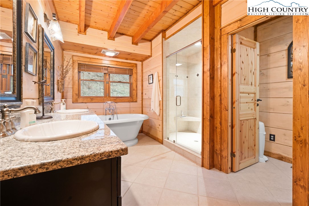 635 Acorn Road Zionville, NC 28698 - Photo 27 of 50 a bathroom with a granite countertop sink and a mirror