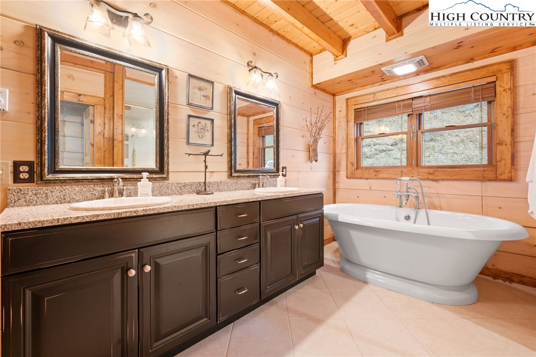 635 Acorn Road Zionville, NC 28698 - Photo 28 of 50 a spacious bathroom with a tub sink double vanity and windows