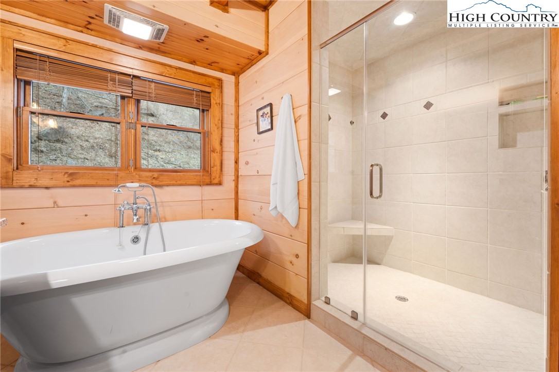 635 Acorn Road Zionville, NC 28698 - Photo 29 of 50 a bathroom with a white bath tub sitting next to a window