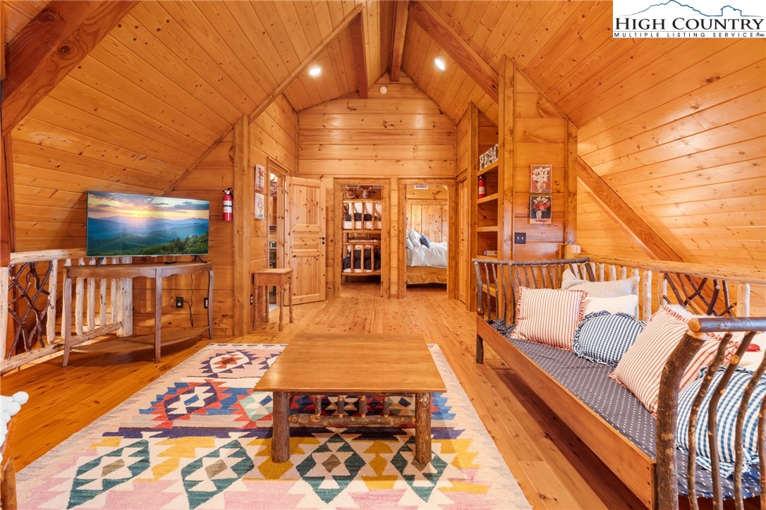 635 Acorn Road Zionville, NC 28698 - Photo 32 of 50 a living room with a rug and a flat screen tv