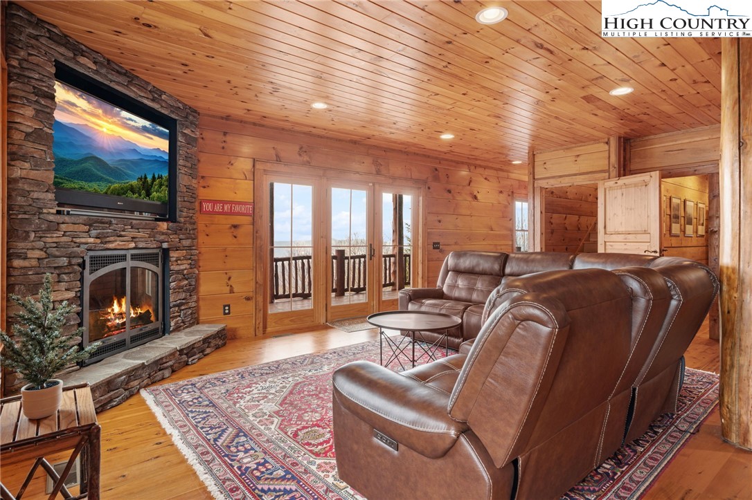 635 Acorn Road Zionville, NC 28698 - Photo 39 of 50 a living room with furniture a flat screen tv and a fireplace
