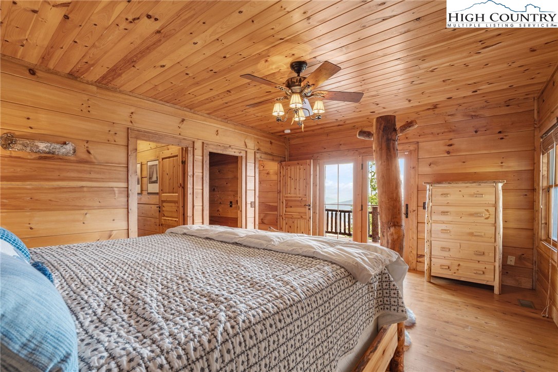 635 Acorn Road Zionville, NC 28698 - Photo 44 of 50 a bedroom with a large bed and a chandelier