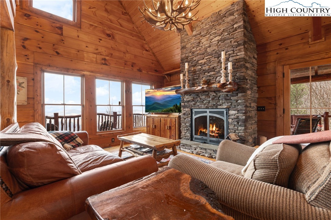 635 Acorn Road Zionville, NC 28698 - Photo 10 of 50 a living room with furniture a fireplace and a flat screen tv