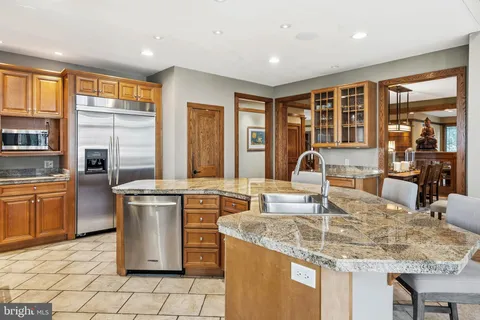 a kitchen with stainless steel appliances granite countertop a stove and more cabinets