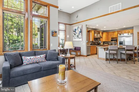 a living room with furniture and large windows