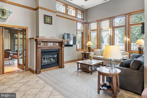 a living room with furniture and large windows