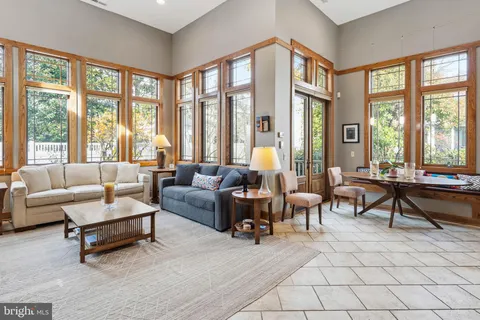 a view of a livingroom with furniture and a large window