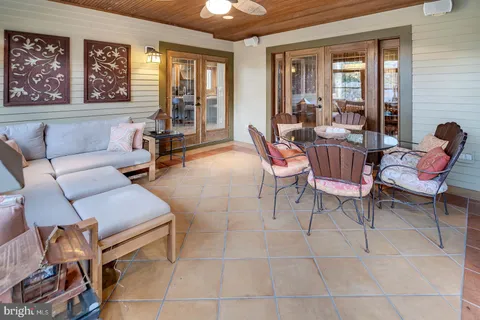 a living room with furniture and large windows