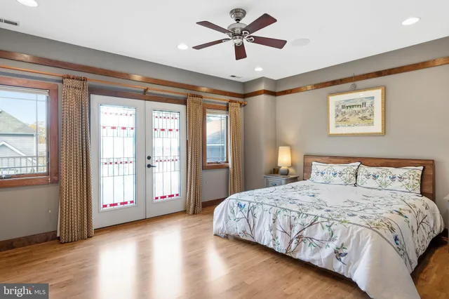 a bathroom with a tub a mirror and a shower