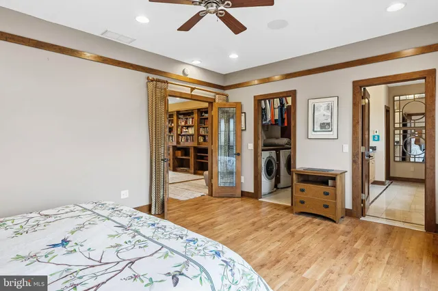 a view of a patio with two couches and deck with wooden floor and fence