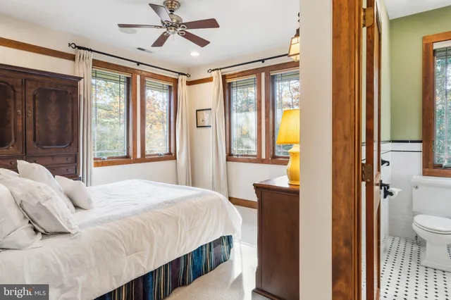a view of a hallway with dining room and wooden floor