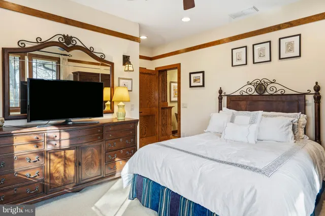 a living room with furniture and a book shelf