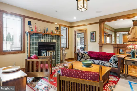 a living room with furniture a rug and a chandelier