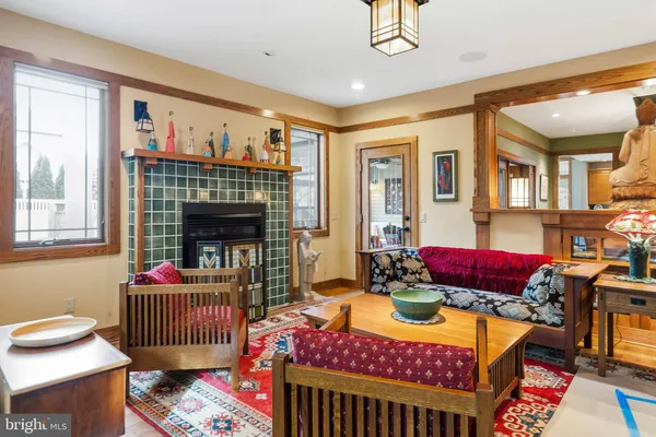 a dining room with furniture a chandelier and wooden floor