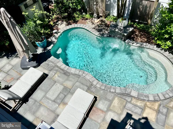 a view of a swimming pool and lounge chairs