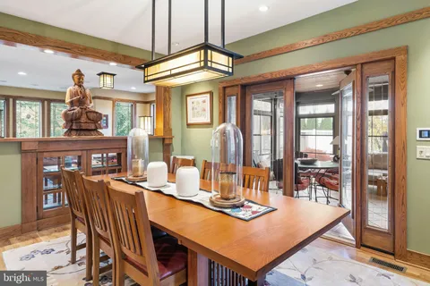 a dining room with furniture a chandelier and wooden floor