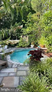 an aerial view of house with yard swimming pool and outdoor seating