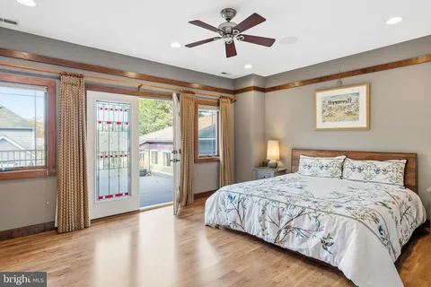 a bedroom with a large bed and a chandelier