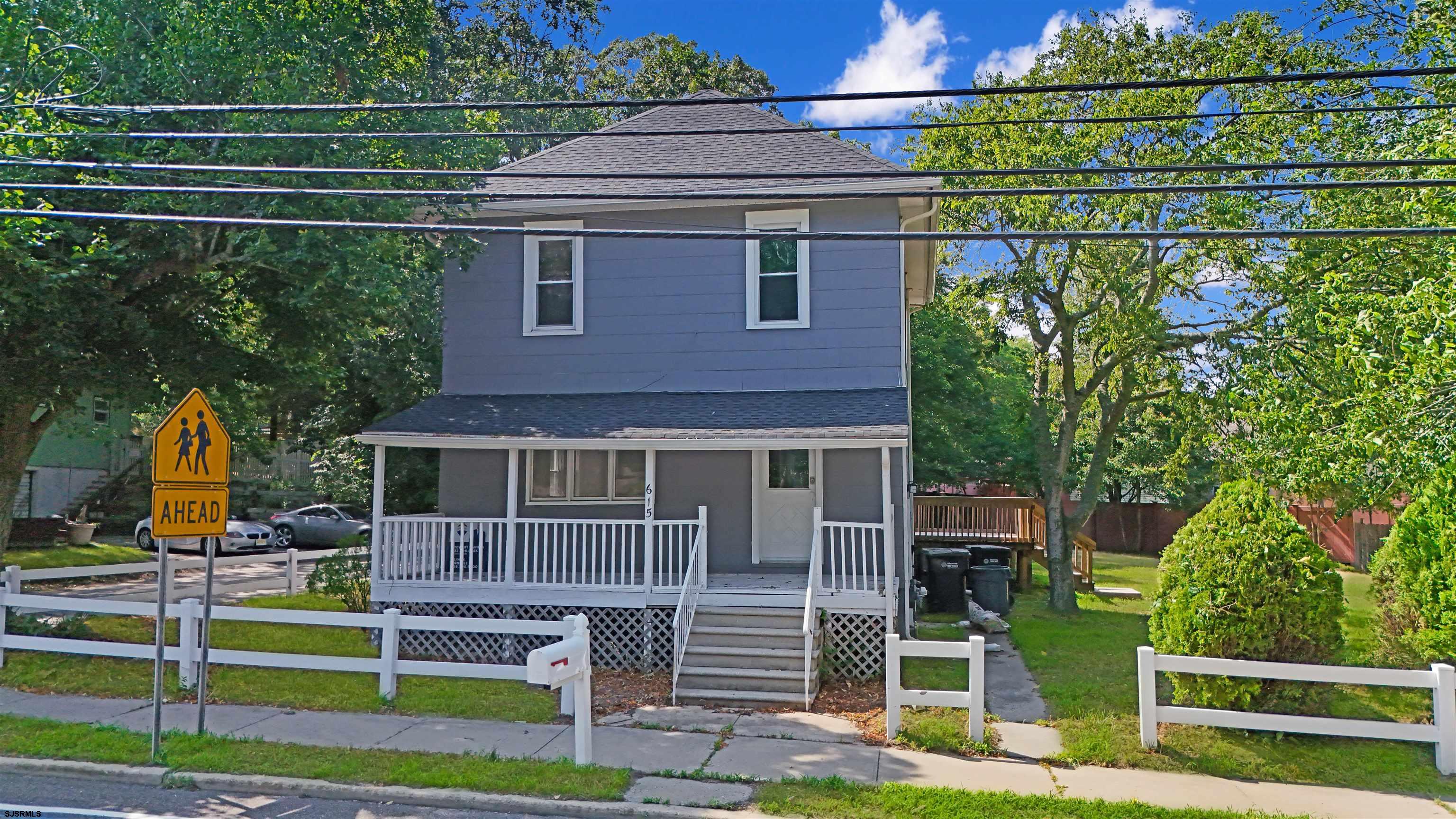 a view of a house with wooden fence