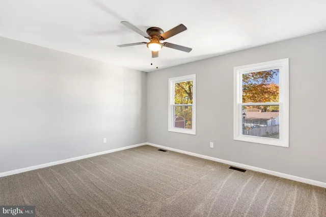 a view of room with a ceiling fan and window