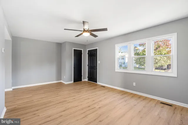a view of a backyard with wooden fence