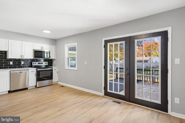a kitchen with granite countertop a stove and a refrigerator