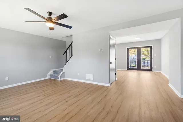 wooden floor in an empty room with a window
