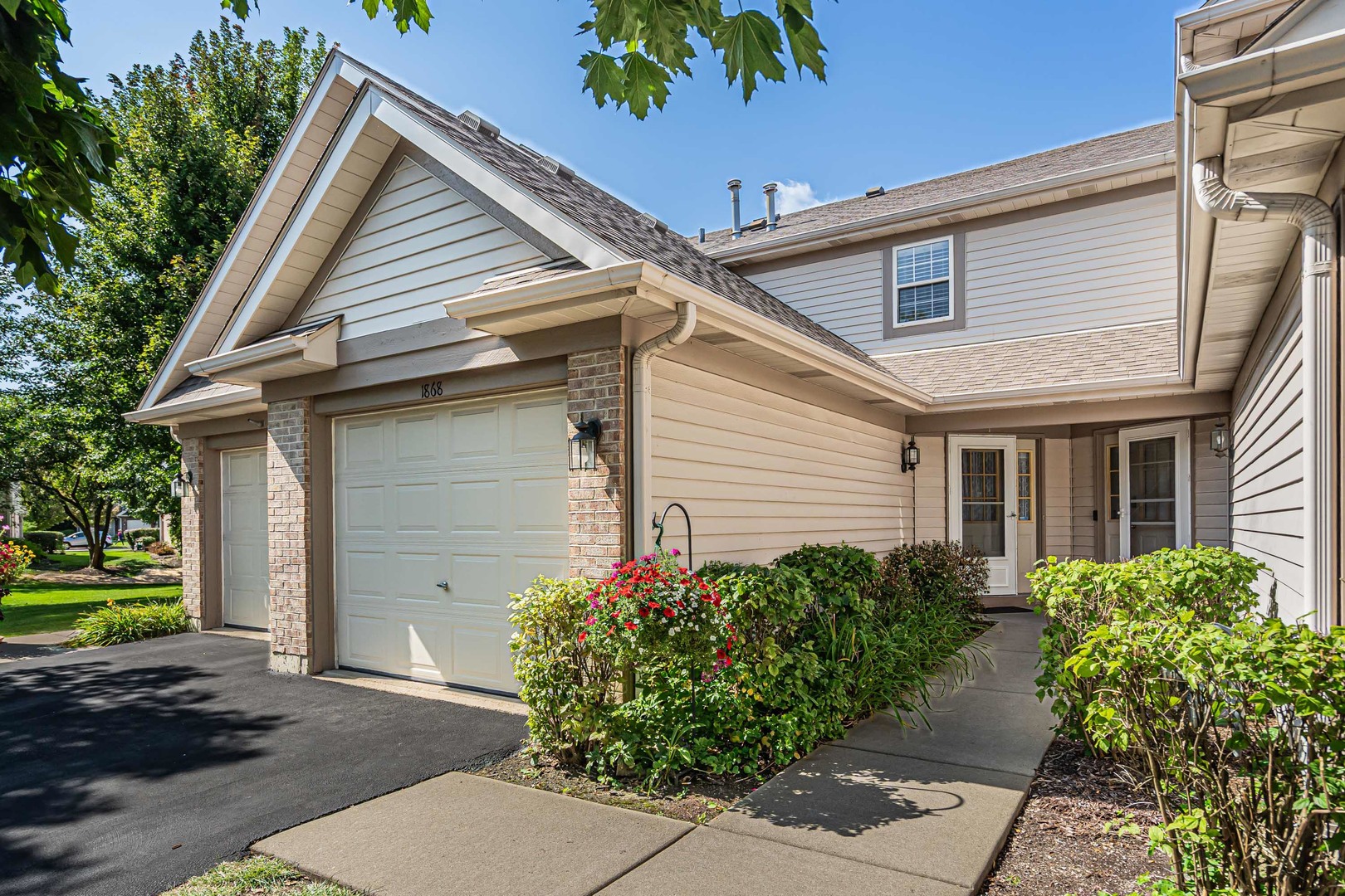 a view of a house with a small yard and plants