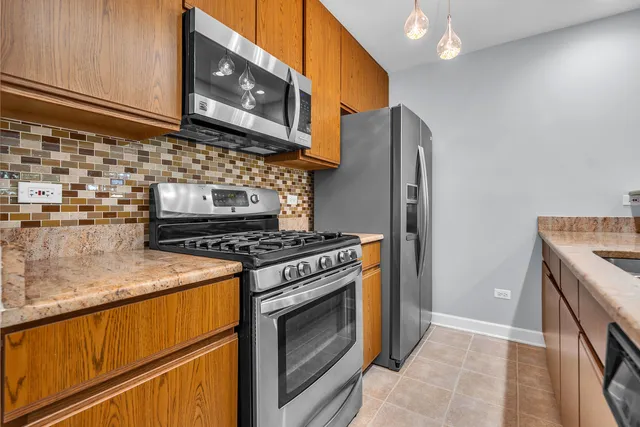 a kitchen with granite countertop a stove and a sink