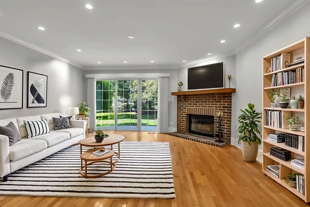 a living room with fireplace furniture and a flat screen tv