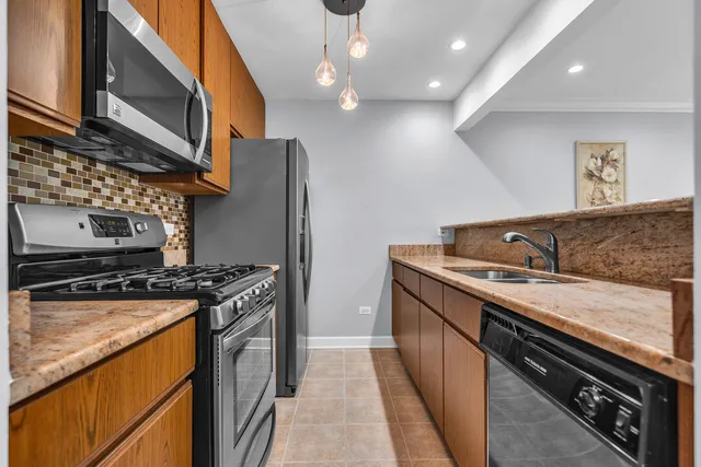 a kitchen with stainless steel appliances granite countertop a stove and a sink