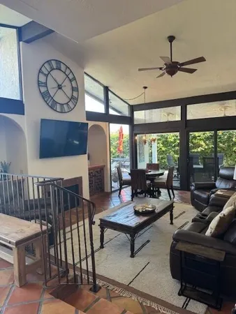 a bedroom with a bed and a flat tv screen on dresser