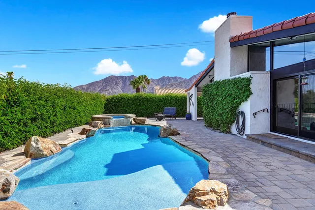 a view of a house with a yard porch and sitting area