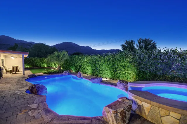 a view of a patio with chairs and table